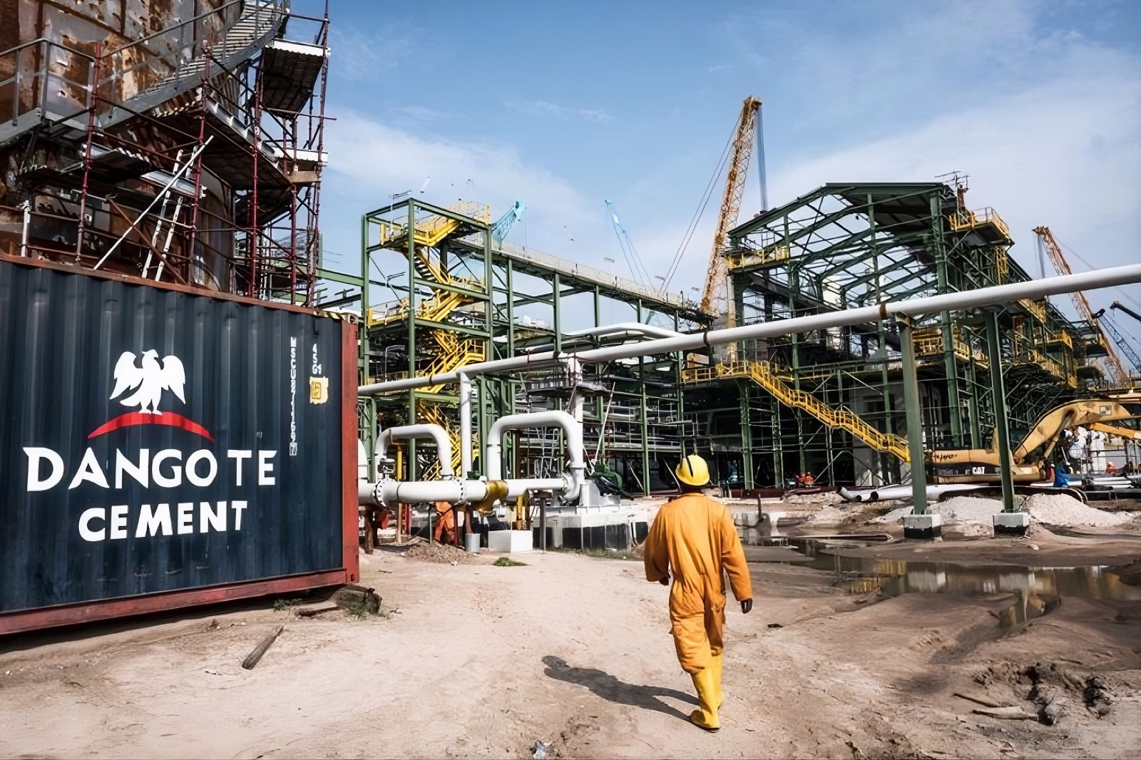Meldex worker on site beside a Dangote Cement delivery